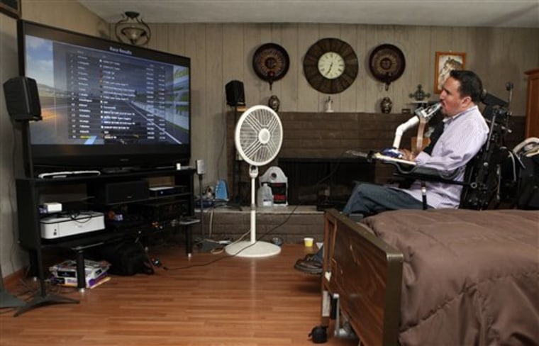 Ruben Rios who is a quadriplegic plays a video game using a special mouth controller in his home in Norwalk, Calif., Thursday, June 2, 2011. When Ruben Rios plays videos games he uses top and bottom lip controls, a cross bar mouth joystick and a number of holes and tubes he can puff or sip into to articulate actions in game. 